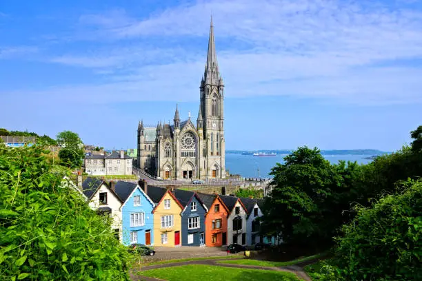 Photo of Colorful row houses with cathedral in background, Cobh, County Cork, Ireland