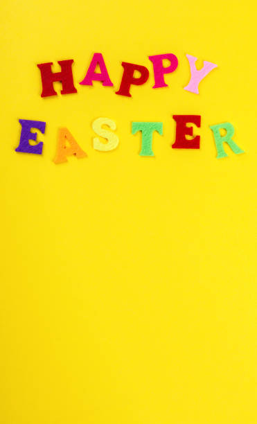 istock Easter concept. Inscription in colored letters Happy Easter on a yellow background.Top View. Flat Lay 1135186733