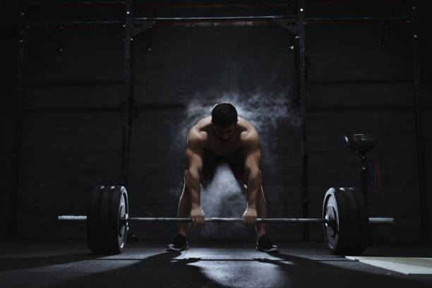 istock Young athlete preparing barbell for lifting weight 1135187663