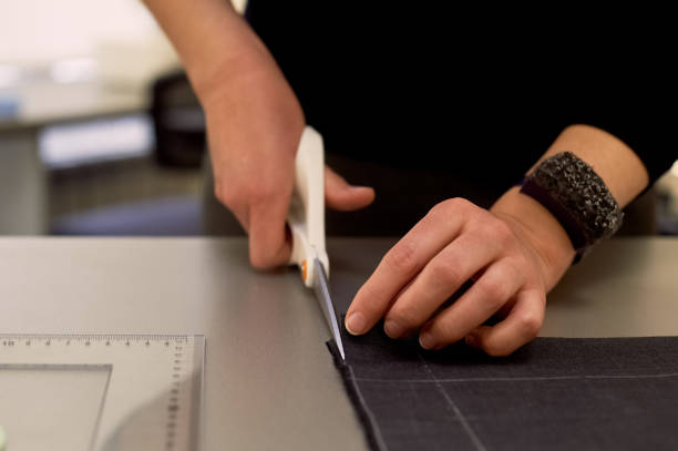 istock Master cuts fabric. Nesting. Suiting fabric marked with white chalk.Cutting and sewing 1135189767