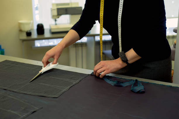 istock Master cuts fabric. Nesting. Suiting fabric marked with white chalk.Cutting and sewing 1135190326