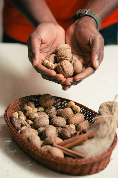 istock Wicker basket on the table and man holding walnuts 1135190451