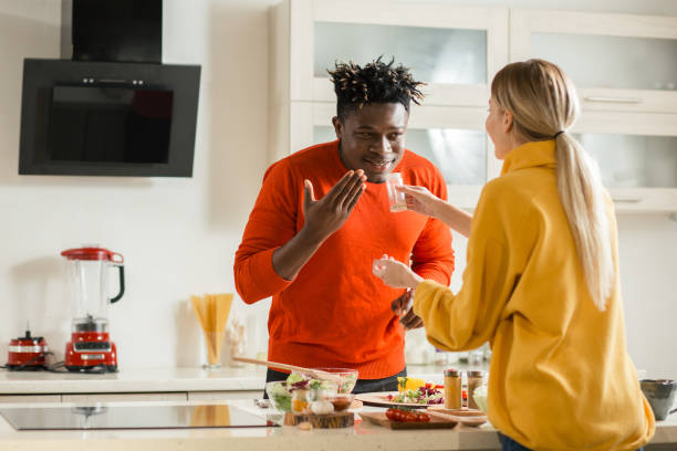 istock Smiling man smelling spices in hand of his girlfriend 1135190856