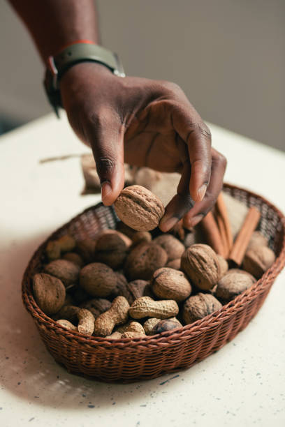 istock Peanuts and walnuts in wicker basket on the table 1135191794