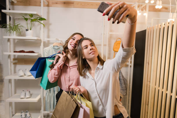 istock Happy girlfriends making selfie with shopping bags 1135193057