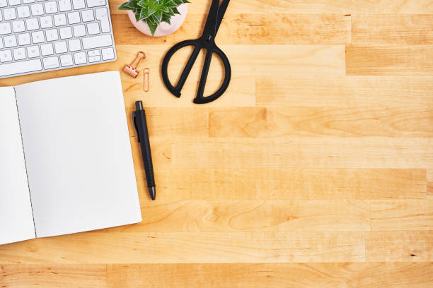 istock Wood office desk table with blank notebook, pen and computer 1135193181