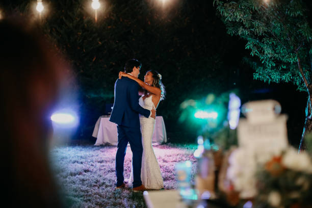 istock Happy wife and groom dancing at night outdoors wedding reception 1135193923
