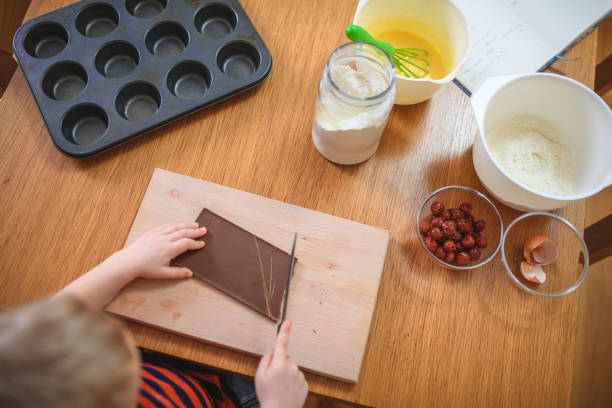 Boy baking muffins at home