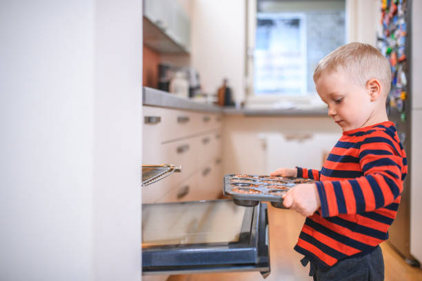 istock Boy baking muffins at home 1135194303