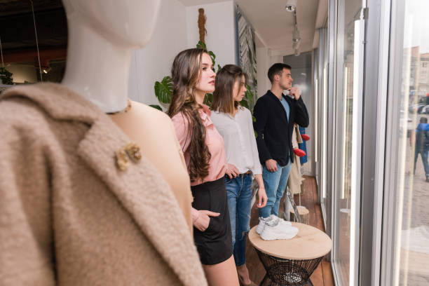 istock Young people stay near mannequin at store window. 1135196021