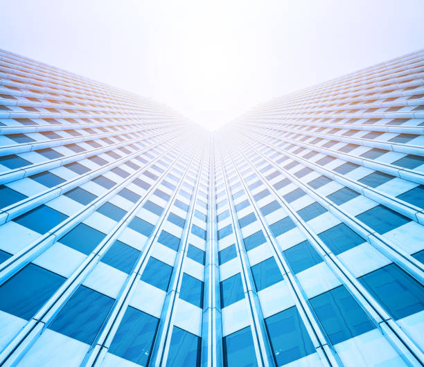 istock looking up view of skyscrapers reflect blue sky 1135197557
