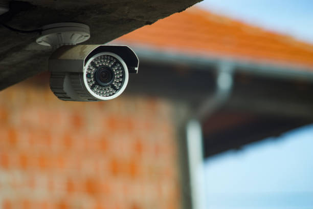 Surveillance security camera under the concrete wall of the building Surveillance security camera under the concrete wall of the building surveillance camera stock pictures, royalty-free photos & images