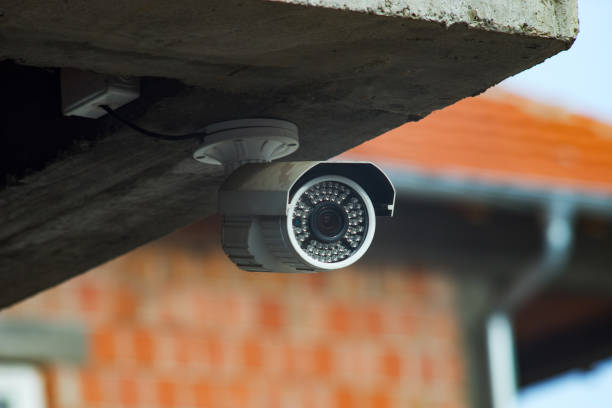 istock Surveillance security camera under the concrete wall of the building 1135200130