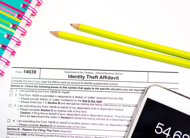 istock IRS Identity Theft Affidavit, Pencils, Calculator 1135200695