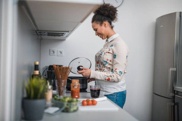 istock African American woman preparing lunch in the kitchen 1135200724