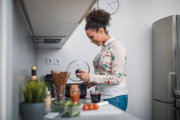 istock African American woman preparing lunch in the kitchen 1135200729