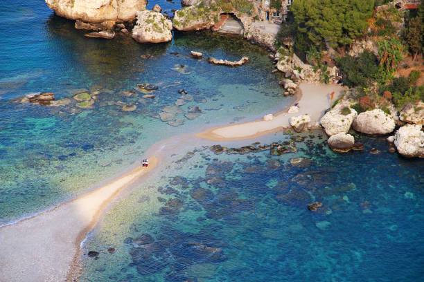 Beach of Isola Bella, Taormina, Sicily, Italy Beautiful beach and sandy path connecting Isola Bella island with Taormina village, Sicily, Italy isola bella taormina stock pictures, royalty-free photos & images