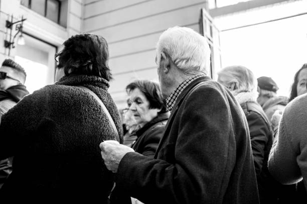 Athens, Greece - February 18, 2019: An unidentified old people waits for a train to arrive in Athens, Greece. The aging population of Athens heavily relies on public transportation to travel around cities.
