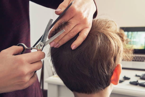 Mom Makes A New Haircut With Scissors And A Comb To Her Sons House A Woman Shears The Boys Hair With Scissors Stock Photo - Download Image Now - iStock Mom Makes A New Haircut With Scissors And A Comb To Her Sons House A Woman Shears The Boys Hair With Scissors Stock Photo - Download Image Now - iStock