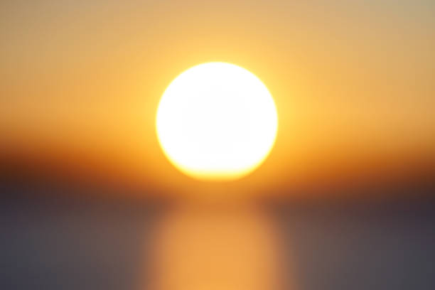 sfoca il grande disco soleggiato arancione brillante al tramonto della giornata nel primo tempo del cielo. - landscape sunny day sunlight foto e immagini stock