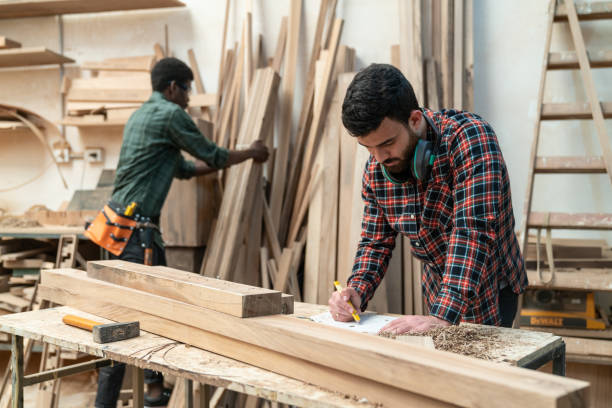 istock Latin american young carpenter working on a design while black man is reaching for wood planks 1135209232