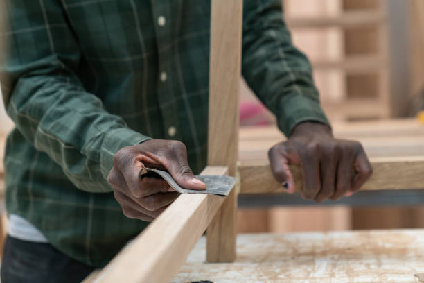 istock Close up of unrecognizable man using sanding paper on a wooden piece 1135209261