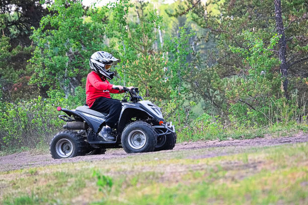 istock A young child rides a quad in a forest 1135209304