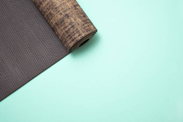 istock New yoga mat on a colored blue background. Top View with copy space. 1135210303