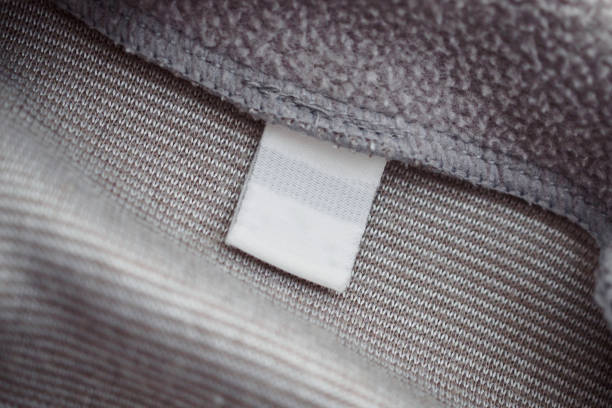 istock blank white clothing label on gray fabric texture background 1135210406