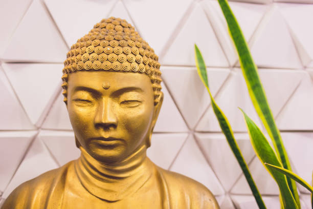 istock Golden buddha statue isolated on white background. 1135210656