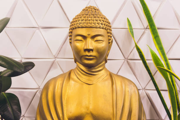 istock Golden buddha statue isolated on white background. 1135210657