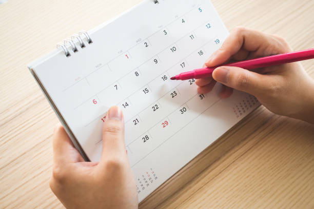 istock Hand with pen writing on calendar page closeup 1135210711