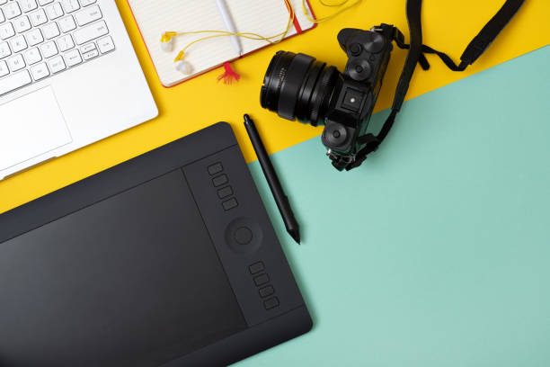 istock Workplace with graphic tablet in digital work and photo editing, view from above. 1135210730