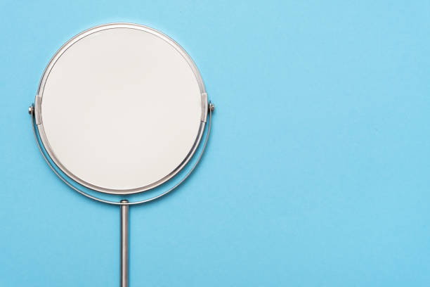 istock Top view image of circle hand mirror on blue background. 1135213338