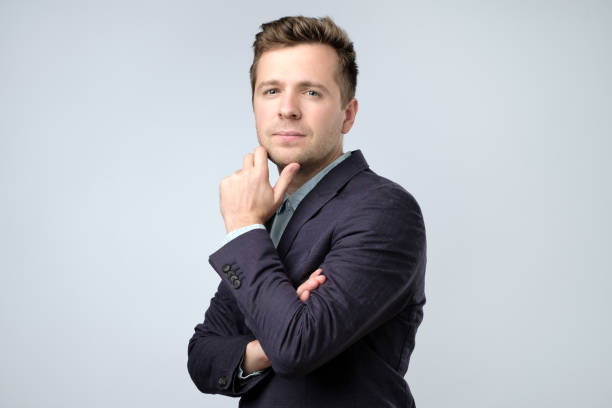 istock Smiling confident man in suit looking at the camera 1135213612