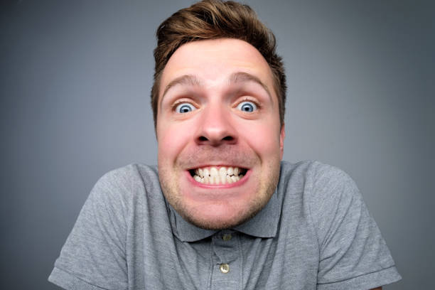 istock happy european man clenching teeth at camera 1135213886