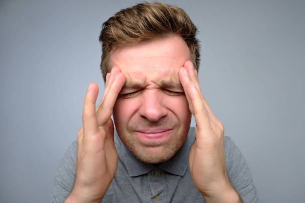 istock Upset unhappy young man squeezing head with hands, suffering from headache. 1135213902