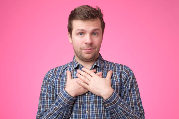 istock Cheerful young man smiles happily, keeps hands on chest, expresses his positive emotions. 1135213935