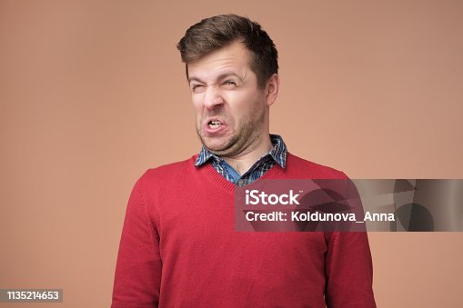 istock Shocked young man looking at something unpleasant and bad 1135214653