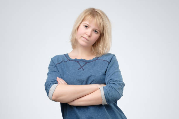istock Upset unsatisfied blonde woman standing with arms folded 1135215080