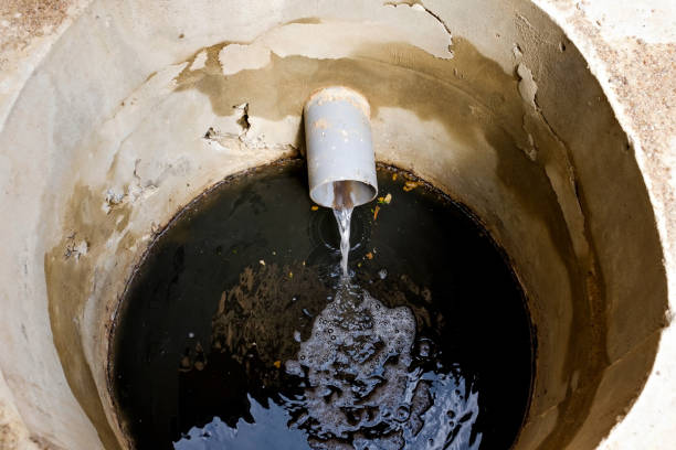 istock Dirty water flowing form pipe in sewage. Top view 1135215365