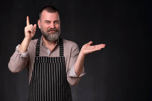 istock Cook provides advice and recommendation, pointing his index finger upwards 1135215370