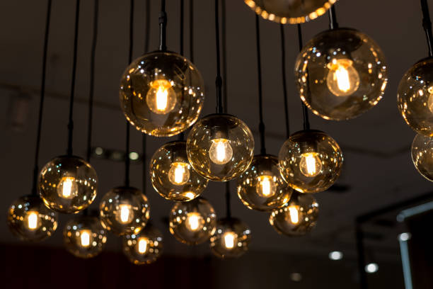 istock many burning incandescent bulbs hanging on the ceiling 1135216272