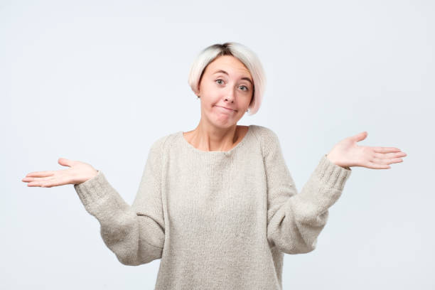 istock Woman shrugs shoulders as does not know answer, being clueless and uncertain. 1135216285