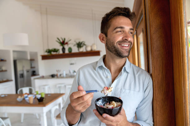 istock Happy man eating breakfast at home 1135216524