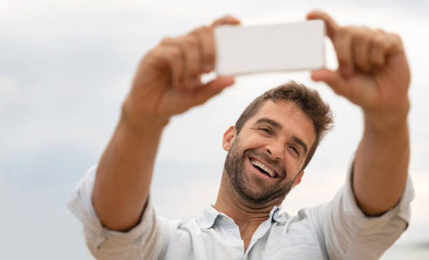 istock Happy man taking a selfie outdoors 1135216536