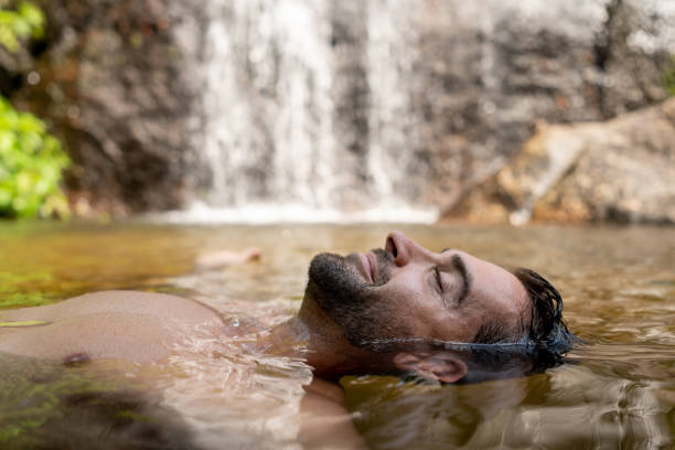 Happy man relaxing and floating in the water