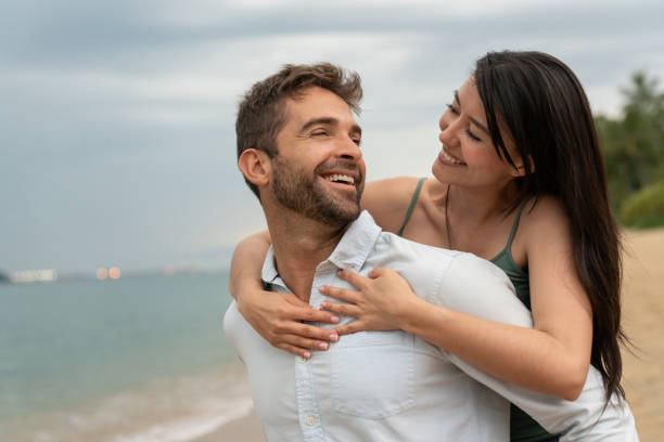 istock Happy couple having fun at the beach 1135216615