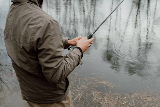 istock Young man is fishing 1135216711