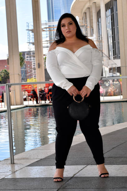 istock Young Woman in White and Black with Purse in Front 1135217492